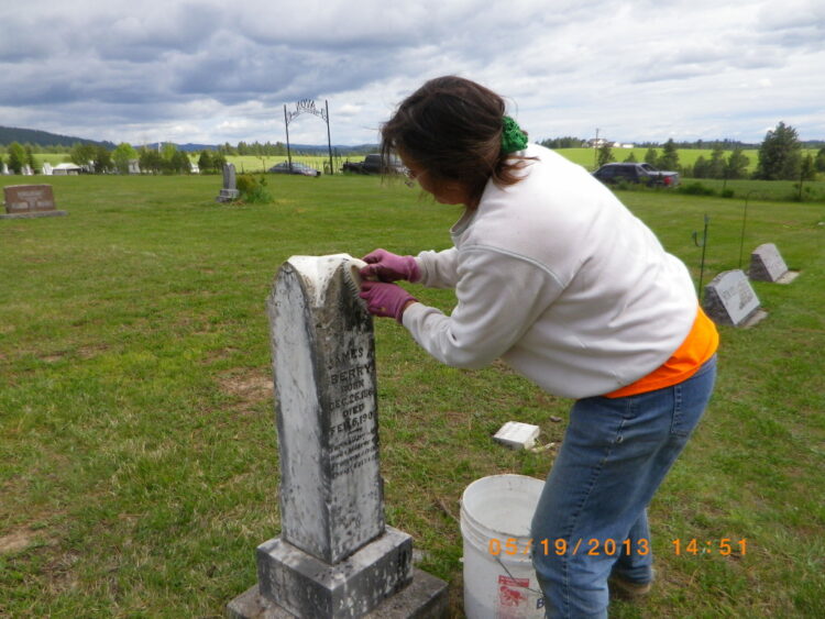 Cleaning epitaphs on the headstones in Avon Cemetery